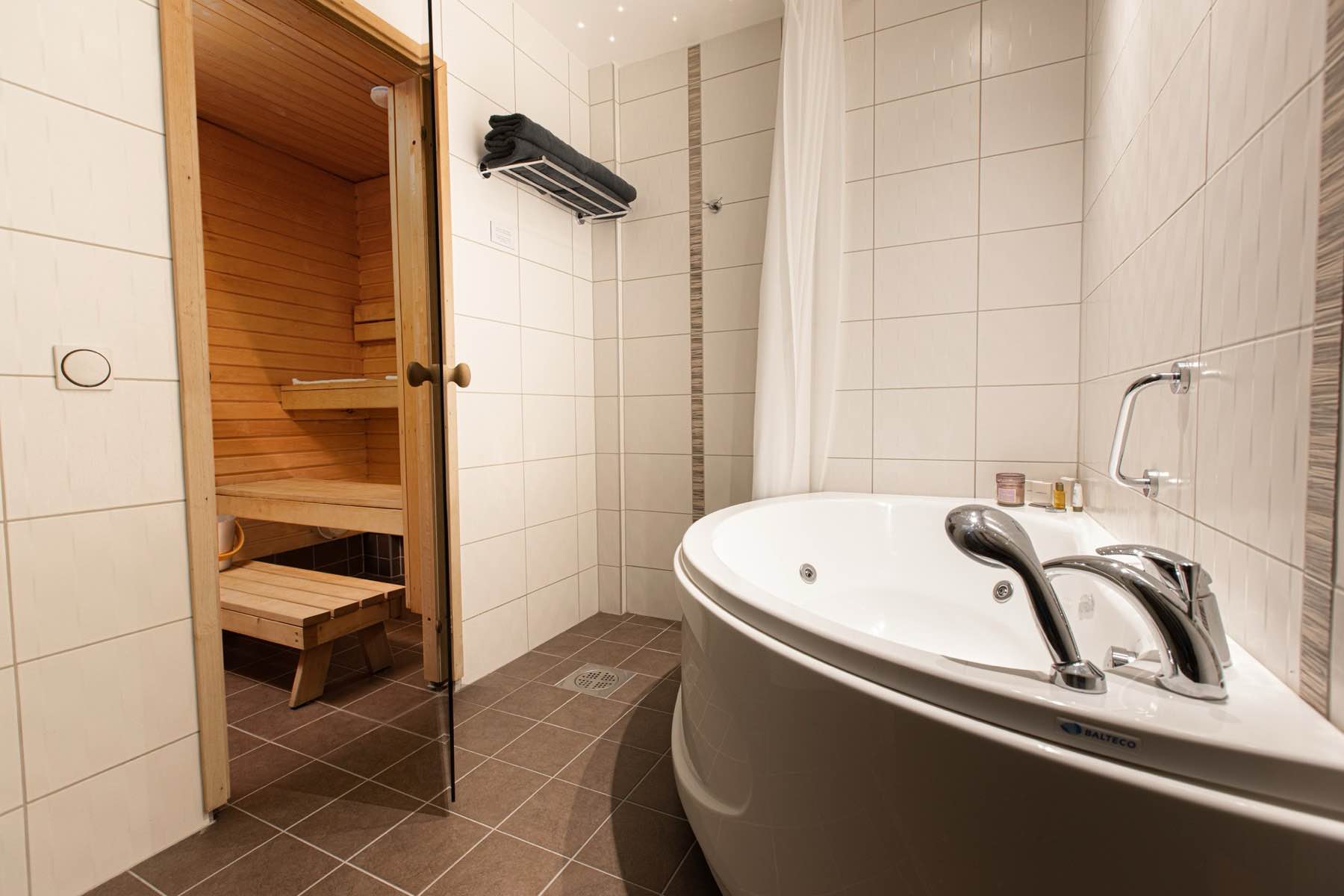 The private sauna and corner jacuzzi in the suite